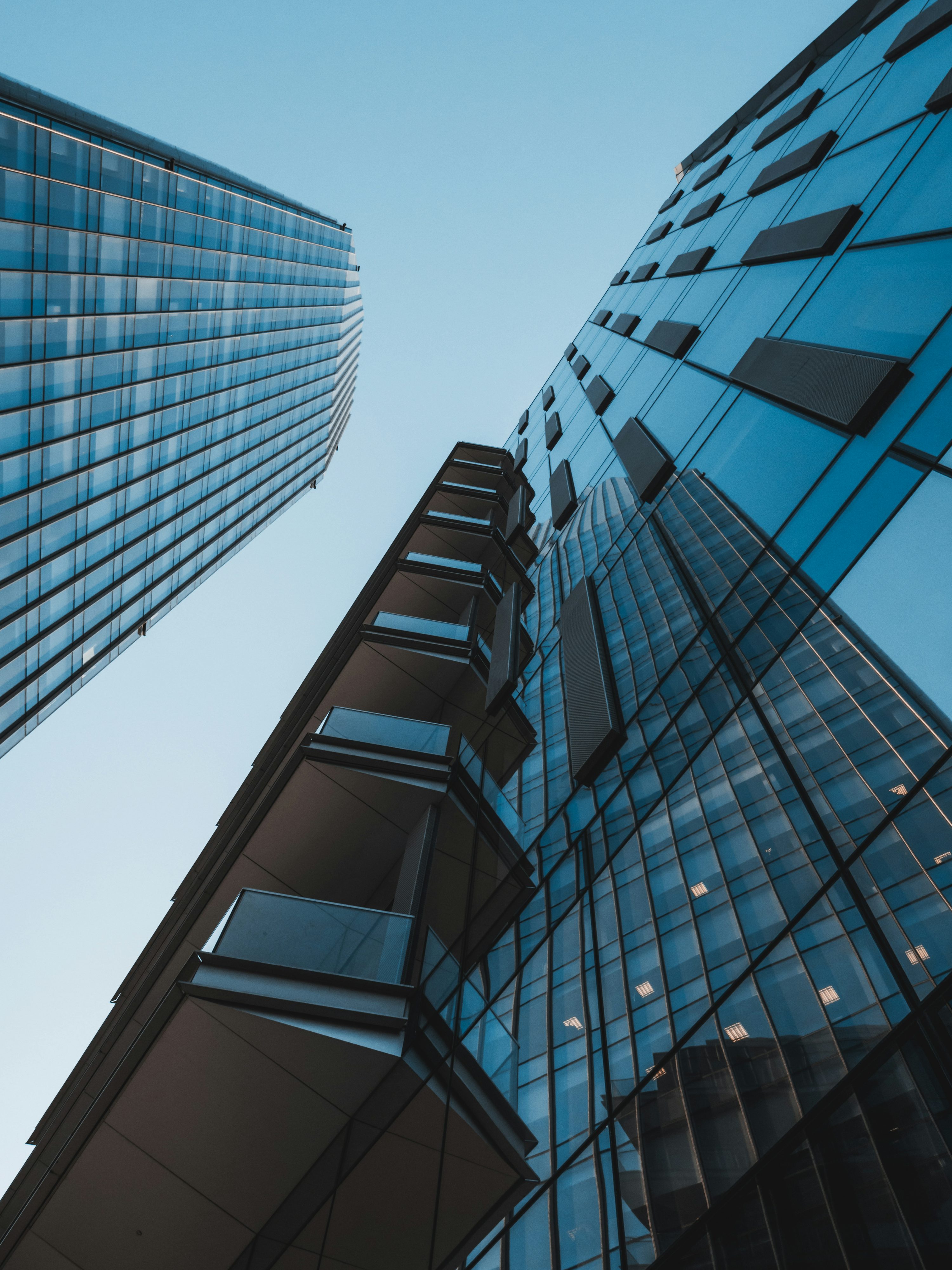 Modern glass office towers against a clear sky